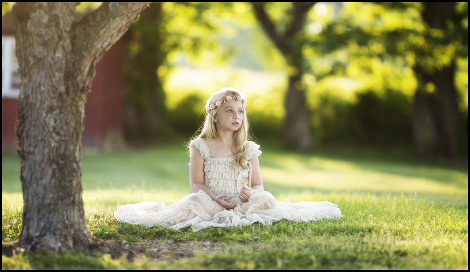 Angelic youth sitting outside rural studio back yard floral crown